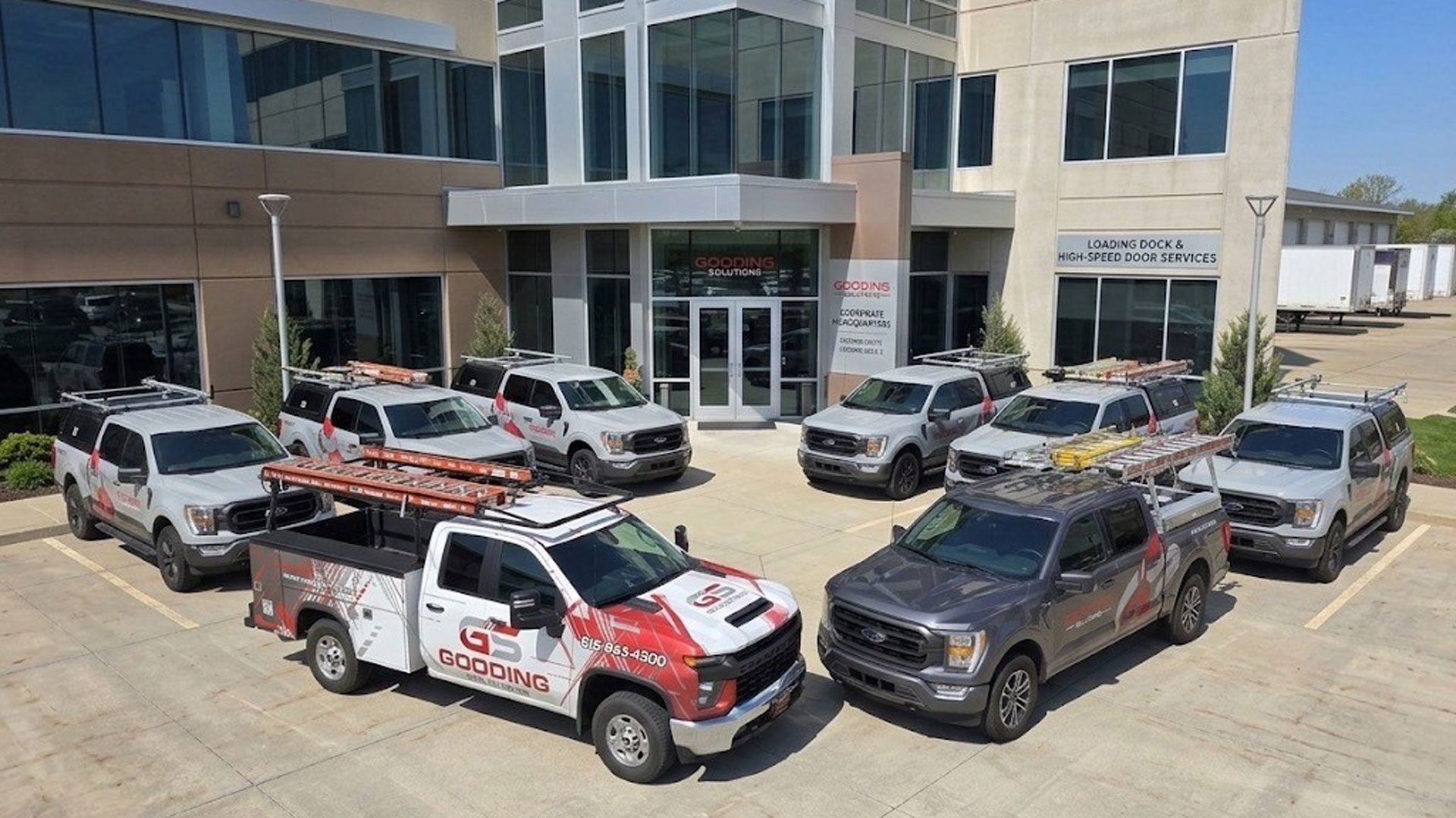 Gooding Solutions industrial door and loading dock service fleet parked outside company headquarters.