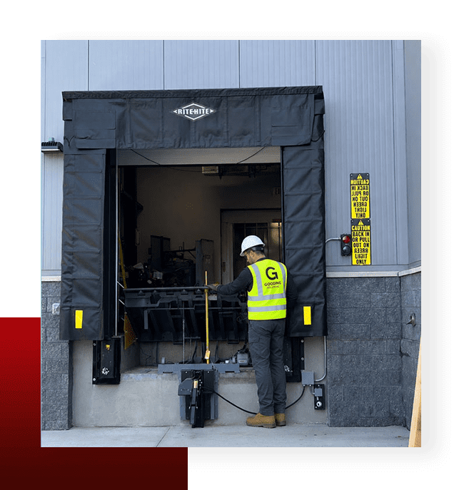 Gooding Solutions technician servicing a warehouse loading dock leveler and dock shelter system.